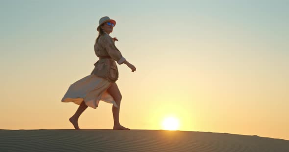 Attractive Lady Walking Barefoot on Sand in Desert During Safari