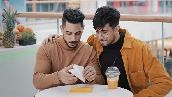 Young Excited Guy Opens Paper Letter Worried Man Supports Friend Read Good News Rejoice Hugging Gets