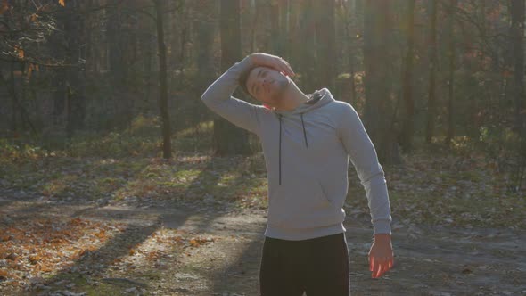 Man Is Stretching In Forest Before Morning Workout