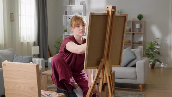 Female Artist Painting on Easel