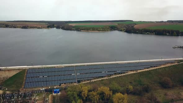 Aerial view of Solar panels near the river. Alternative source of electricity. Solar farm.