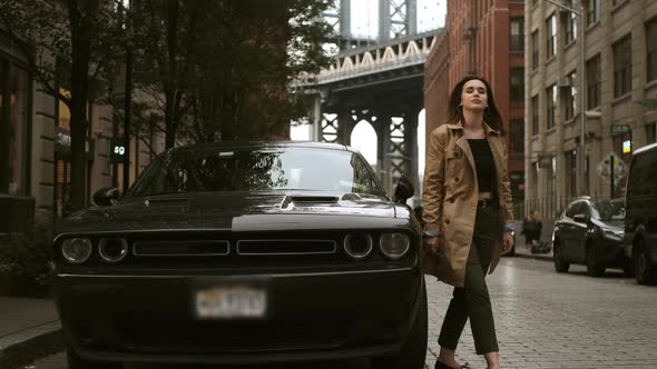 Attractive Woman Walks Near An Expensive Car. Brooklyn, New York.