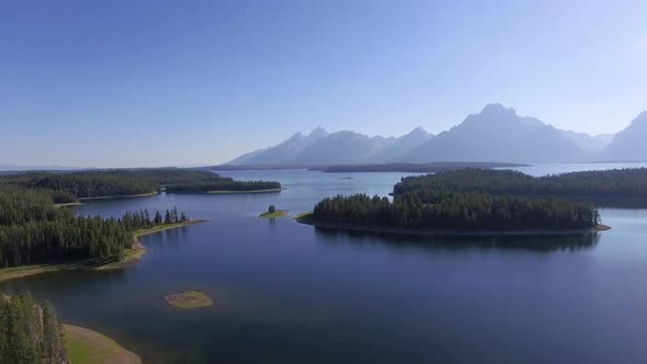 Above Jackson Lake the camera flies backwards to reveal more of the environment