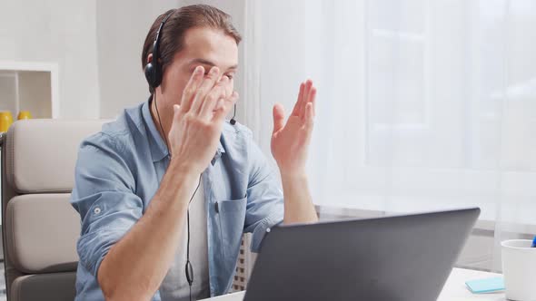 Workplace of freelance worker at home office. Young man works using computer.