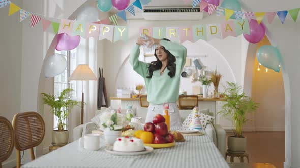 Asian girl preparing the dining table for the birthday party