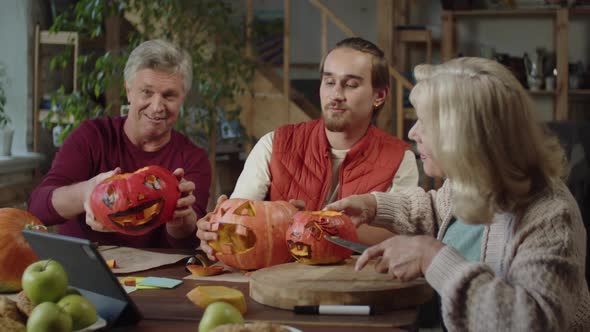 A Young Man and His Parents are Making a Video of Their Halloween Pumpkins