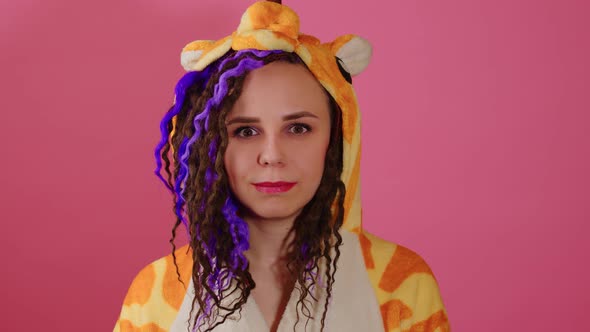 Young Optimistic Beautiful Woman in Kigurumi Looking at Camera Smiling on Pink Background