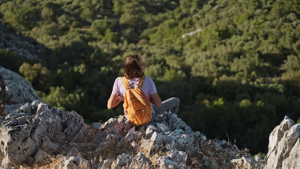 Rear View Happy Girl Stands on Edge of High Cliff Enjoying Beautiful Seascape of Aegean Coastline