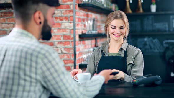 Pretty Female Barista Serving Coffee Cup for Male Customer Enjoying Positive Emotion