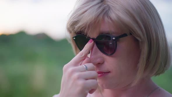 Closeup of Confident Queer Transgender Woman in Sunglasses Standing Outdoors Looking Away