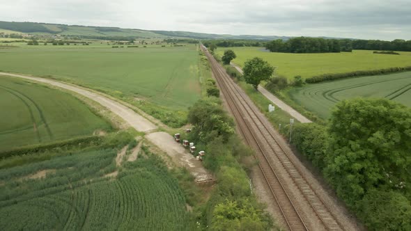 aerial view of rail way track in rural UK countryside drone fly over