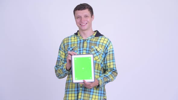 Happy Young Handsome Man Showing Digital Tablet
