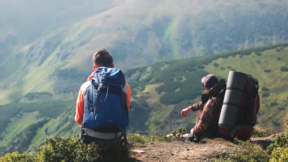 Tourists Sitting on the Hill in Ukrainian Carpathians