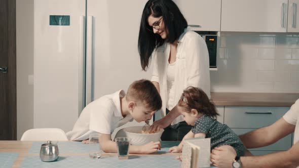 Young Family Preparing Food in Kitchen at Home