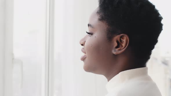 Young Afro American Woman Looking Through Window