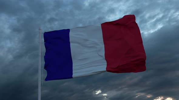 Realistic Flag of France Waving in the Wind Against Deep Heavy Stormy Sky