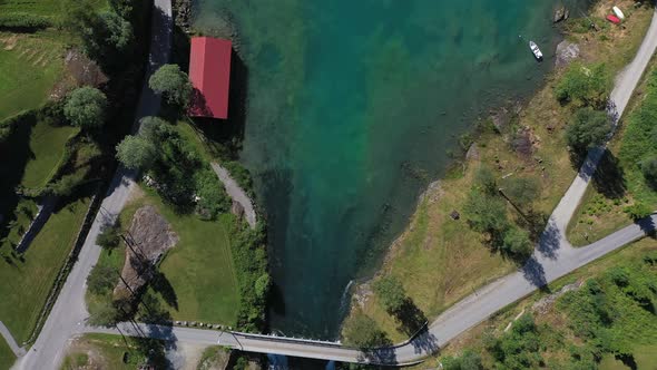 Beautiful birdseye aerial showing bottom of Lovatnet lake with start of river and moving on to fill