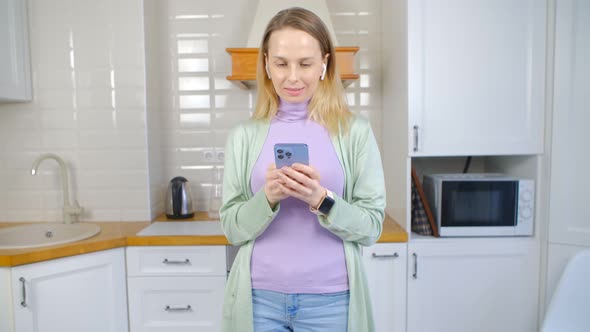 Happy blonde female using modern smart phone for communication on social media app in 4k video