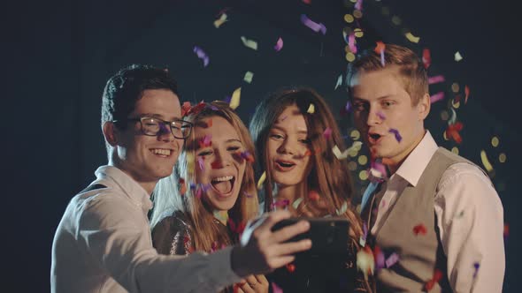 Smiling Multiracial Friends Throw Confetti, Posing and Taking Selfie on Smartphone or Mobile Phone