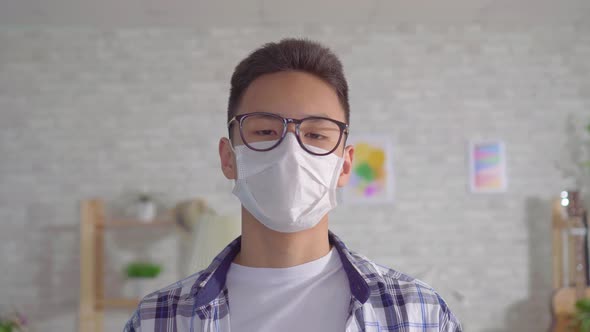 Young Sian Man in Protective Medical Mask