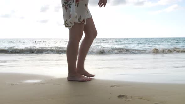 Barefoot Lady in Summer Dress Walks Along Empty Sea Beach