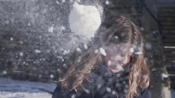 Cute Little Girl Outdoors Dodging Snowball Being Thrown At Her