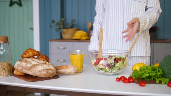 Female Cooking Healthy Salad In The Kitchen. Closeup