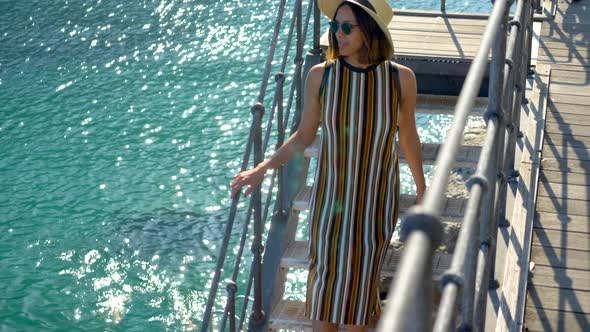 A woman on a ladder in a luxury resort town in Italy, Europe