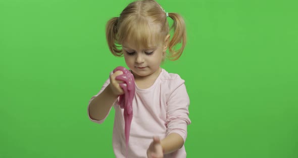 Kid Playing with Hand Made Toy Slime. Child Having Fun Making Pink Slime