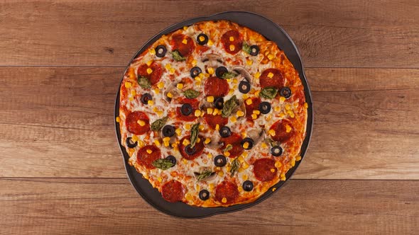 top view of making pizza on slowly rotating baking plate - stop motion animation
