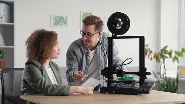 Portrait Young Talented Work Team Man and Woman are Discussing Printing Prototype on 3d Printer at