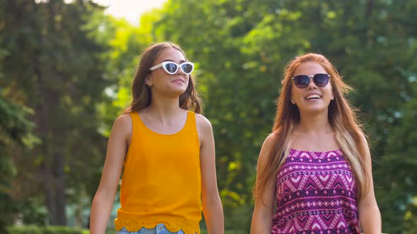 Teenage Girls or Friends Walking in Summer Park