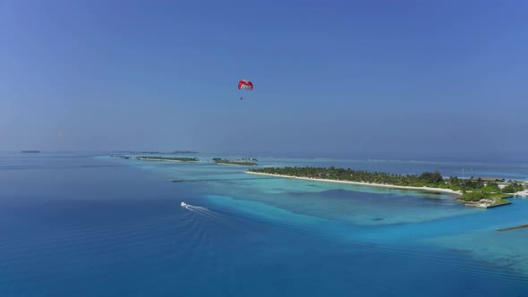 Aerial Shot of south male atoll with paraglider