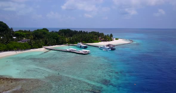 Natural aerial island view of a paradise sunny white sand beach and aqua blue ocean background in hi