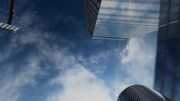 The business center camera climbs sharply upward along the mirrored high-rise buildings