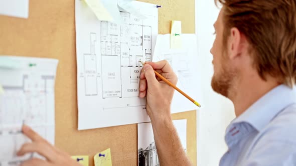 Architector Standing Near Board Working with Drawings Close Up Slow Motion
