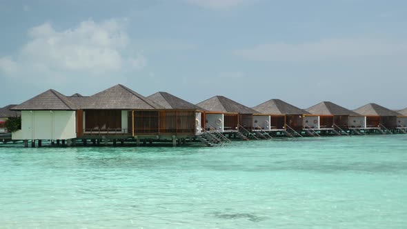 Luxury Overwater Villas on Turquoise Lagoon White Sandy Beach in Maldives