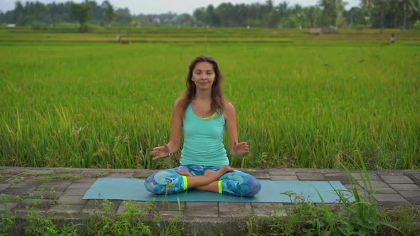 Slowmotion Steadicam Shot of a Young Woman Doing Meditation for Muladhara Chakra in a Balinese Way