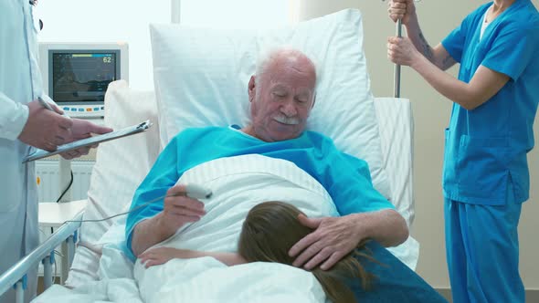 Girl visiting her grandfather in hospital room