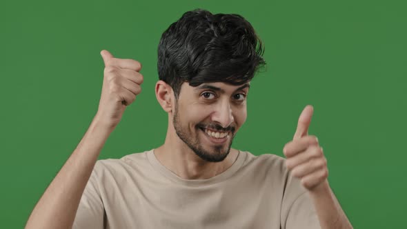 Friendly Arabic Man Stand in Green Studio Make Thumb Up Gesture Both Hands Show Like Everything Okay