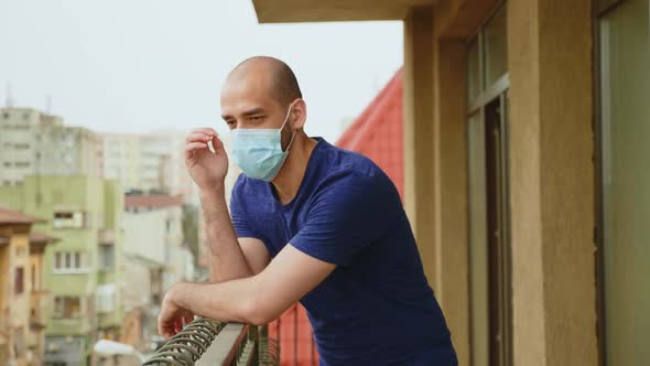 Sad Man on the Balcony During Coronavirus Isolation