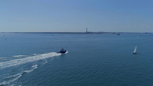 Tug Boat Moving Through the Sea in the Summer