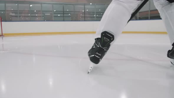 Hockey Player Dribbling Puck While Skating