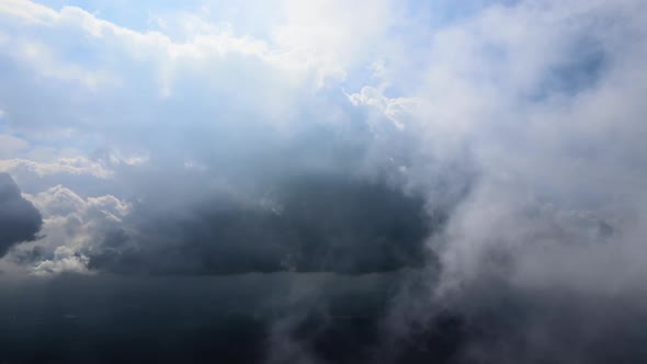 Aerial View at High Altitude of Dark Cumulus Clouds Forming Before Rainstorm