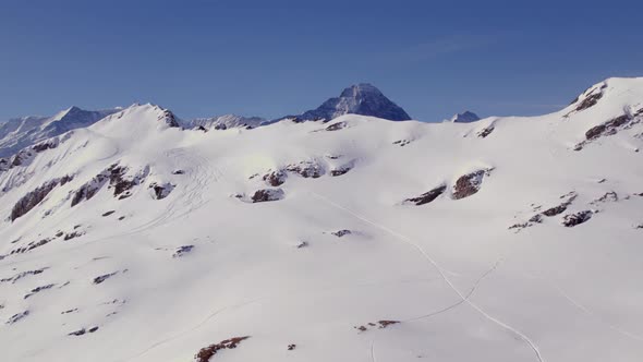 Aerial winter drone footage bottom up revealing Fiescherhoerner, Eiger North Face and Jungfrau in Sw