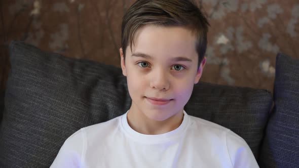 Closeup Portrait of Cute Boy 11 Years Old Looking at Camera at Home