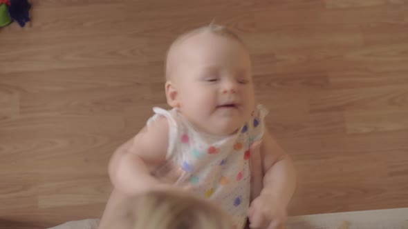 Mum playing with baby daughter and kissing her