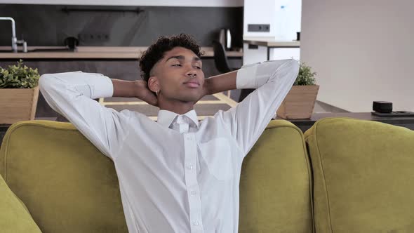 Attractive Healthy Calm Young Afro Man in White Shirt Relaxing on Comfortable Sofa Napping Feel