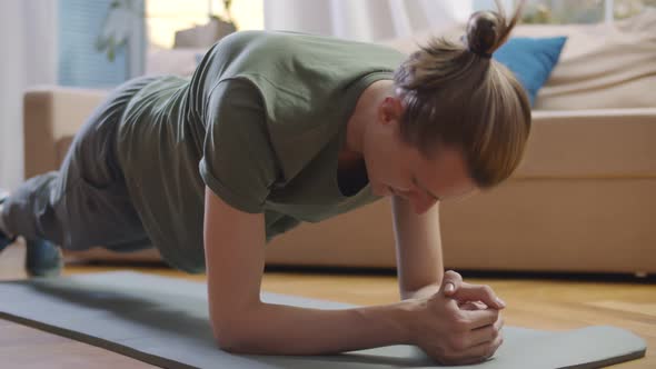 Young Caucasian Man Having Workout on Fitness Mat at Home