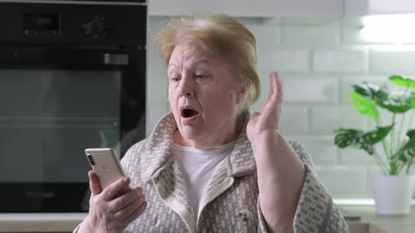 Elderly Woman Talking Participate in Videoconference Using Mobile Phone and Internet Connection